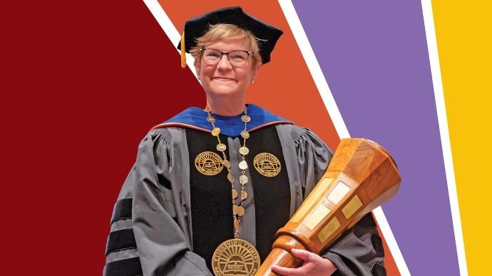 A portrait of President Beasley holding the presidential mace with colorful rays behind her